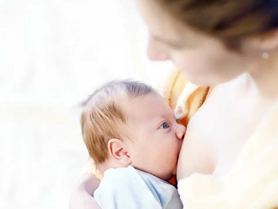 Mother breastfeeding baby, featured on baby feeding advice and breastfeeding support page